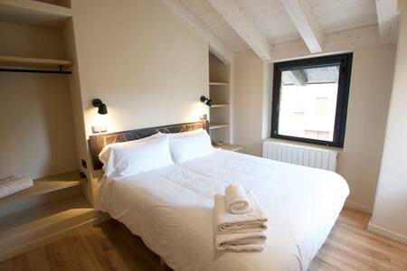 Dormitorio con cama doble y ventana